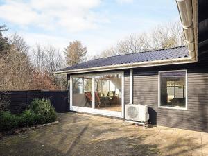 a screened in porch of a house at Seaside Charm in albaek - By Traum Ferienwohnungen in Spottrup
