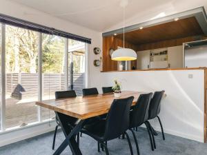 a kitchen and dining room with a wooden table and chairs at 7 person holiday home in Spøttrup in Spottrup