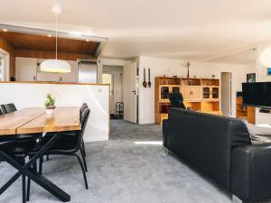 a dining room and living room with a table and chairs at 7 person holiday home in Spøttrup in Spottrup