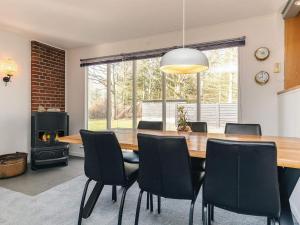 a dining room with a large wooden table and chairs at 7 person holiday home in Spøttrup in Spottrup +21 photos
