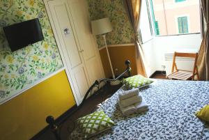 a bedroom with a bed with pillows and a television at Casa Fanti 57 in Rome