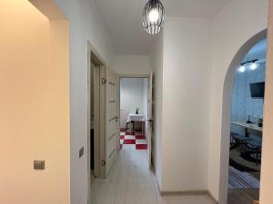 a hallway with a white wall and a light fixture at Chișinău Airport Comfort in Chişinău