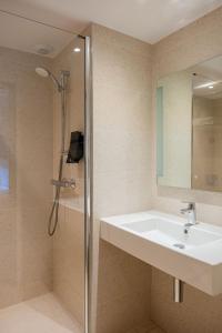 a bathroom with a sink and a shower at Citybox Brussels Centre Louise in Brussels