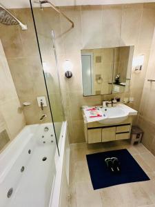 a bathroom with a tub and a sink and a shower at Centaurus Apartment 3 Bedroom in Dargai +53 photos