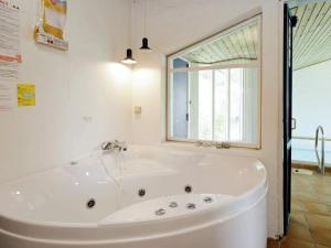 a white bath tub in a bathroom with a window at 8 person holiday home in Fjerritslev-By Traum in Slettestrand
