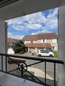 a view of a car parked outside a house at Roissy CDG, private room 1 in Roissy-en-France
