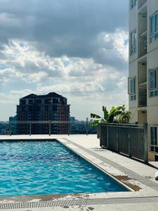 a swimming pool on the roof of a building at Cozy Staycation with Netflix, Pool, PS4, Board Games in Manila