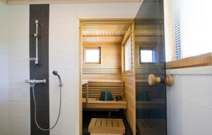 a small bathroom with a shower and a sink at Villa Vallaton 3 Bedroom Apartment in Jämsä +21 photos