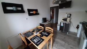a kitchen with a table and chairs in a room at Apartment Banska Bystrica, Podlavice in Banská Bystrica
