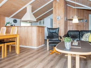 a living room with a table and chairs at 6 person holiday home in Rømø in Bolilmark