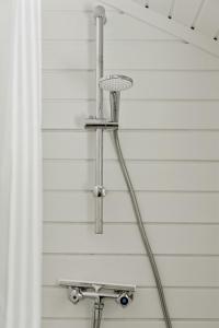 a shower head in the corner of a house at Experience Nature's Embrace And Peace in Græsted