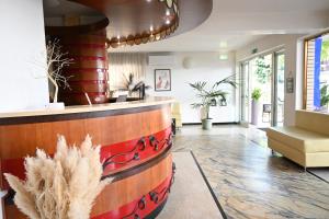 a lobby with a bar with a wine barrel at Hotel B&B Ardea Rimini in Rimini