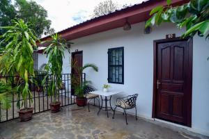 a patio of a house with a table and chairs at Studio Ground Floor Room by Densy Angkor in Siem Reap