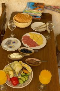 a wooden table with plates of food on it at Soléi Old Town in Siwa +21 photos