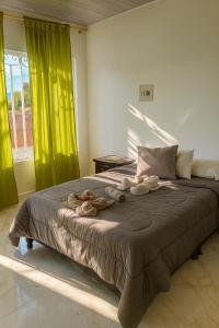 a bedroom with a large bed with stuffed animals on it at Apartamento central Wiky House in Guaduas