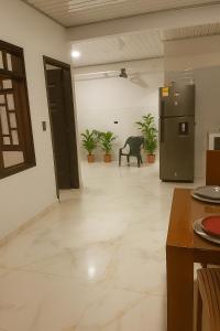 a kitchen with a refrigerator and some plants at Apartamento central Wiky House in Guaduas