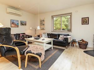 a living room with a couch and a table at Beachside Serenity-By Traum in Løkken
