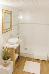 a white bathroom with a sink and a mirror at Home Sweet Zen, appartement près de la gare St Jean in Bordeaux