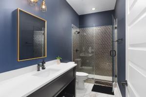 a bathroom with a sink and a toilet and a shower at Hip New Condo near Broadway and Trendy East Nash with 5 Beds in Nashville