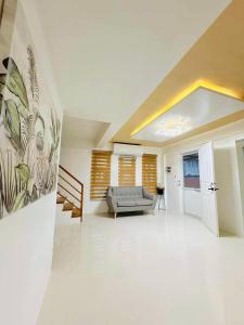 ein Wohnzimmer mit einer Couch und einem Gemälde an der Wand in der Unterkunft Elegant 3 Bedroom House near Airport in Sampong