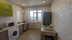 a kitchen with a washer and dryer in it at 1 кімнатна квартира in Sumy