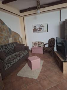 a living room with a couch and a tv at Casa Giulia in Monopoli