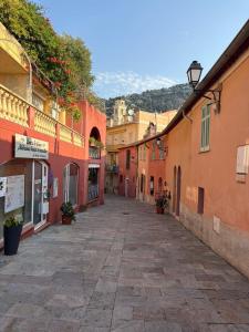 un callejón en una ciudad con edificios naranjas en Charmant 2 pièces rénové avec vue mer, en Villefranche-sur-Mer