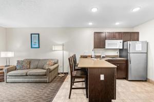 a living room with a couch and a kitchen at Independence Stay Long Term and Suites in Marinette +10 photos