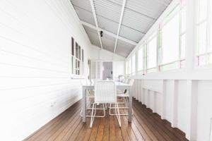 a white room with a table and two chairs at Urban Getaway Colonial 6 beds 2 bath aircon pet family in Bundamba +65 photos
