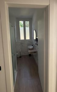 a bathroom with a sink and a mirror and a window at La Casetta in Burago di Molgora +5 photos