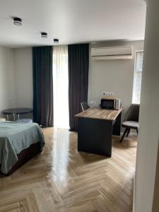 a bedroom with a bed and a desk in it at Apartment in Poti in Poti +4 photos