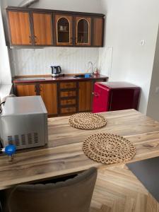 a kitchen with a wooden table with a microwave at Apartment in Poti in Poti