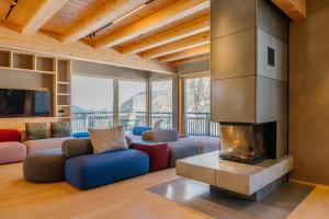 a living room with a couch and a fireplace at Bergchalet Gastein in Dorfgastein