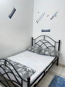 a bedroom with a bed with aluminium sheets on it at Mlimani city studio apartment in Dar es Salaam