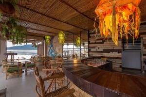 a restaurant with a bar with chairs and tables at Tropical Serenity - Elegant 1 Bedroom with Pool in Ban Saiyuan (1)