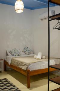 a bedroom with a bunk bed and a lamp at Vila Maré in Itacaré