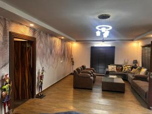 a living room with couches and a couch and a table at Nagarkoti farmhouse in Jāmb