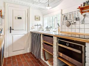 a kitchen with a sink and a stove at 4 person holiday home in Tønder in Tønder +25 photos