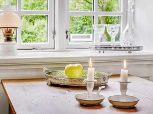 an apple in a tray with candles on a table at 4 person holiday home in Tønder in Tønder +26 photos