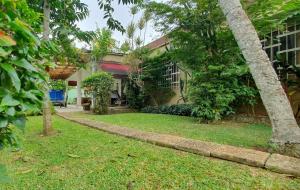 a yard in front of a house with trees at Maison Sigafing in Abidjan