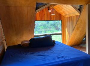 a bed in a room with a large window at Casa para Rallystas in Capitán Miranda