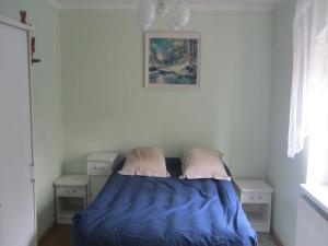 a bedroom with a bed and two night stands at Holiday Home Stara Kamienica near Ski Slopes in Stara Kamienica