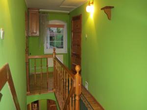 a green room with a staircase with a green wall at Holiday Home Stara Kamienica near Ski Slopes in Stara Kamienica