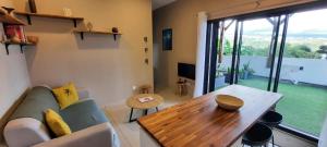 a living room with a couch and a wooden table at Nou Dor Ter La in Entre-Deux