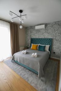 a bedroom with a bed with two towels on it at Waterfront Cosy Studio Nest in Sajmište