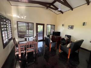 a living room with a wooden table and chairs at Vale Kau in Nadi