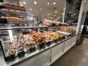 a bakery filled with lots of different types of pastries at Lilypad of Three Kings Guest Rooms in Auckland