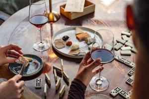 a table with a plate of food and glasses of wine at Fairlawns, Hotel And Spa in Walsall