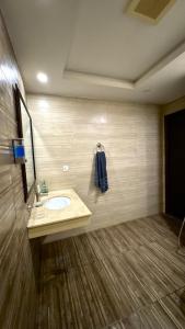 a bathroom with a sink and a mirror at Modern 1BR Apartment Bahria Heights 1 in Rawalpindi +13 photos