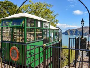 a small green train on a playground next to the water at The Loft, Lynmouth - Uk41697 in Lynmouth +4 photos